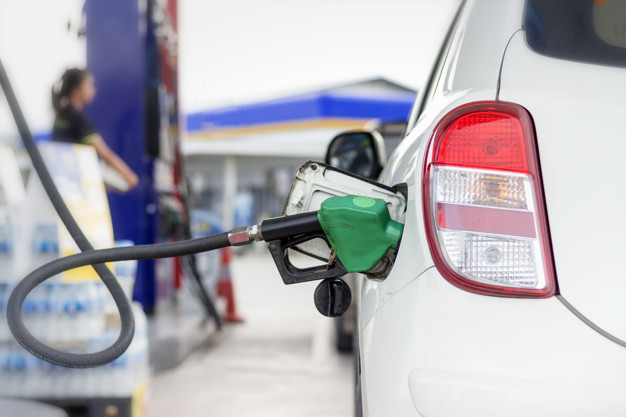 white-car-refueling-gasoline-by-auto-dispenser-nozzle-at-petrol